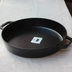 Grand plat rond à anses en fonte noire